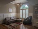 Comfortable living room area featuring a large window, plush seating, and stylish decor at 212 Wilshire Ter, White, GA 30184