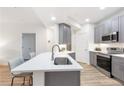 Kitchen with stainless appliances, gray cabinets, and a stylish island at 2700 Pine Tree Ne Rd # 2201, Atlanta, GA 30324