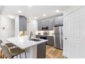 Modern kitchen featuring stainless steel appliances, gray cabinets, and a quartz countertop island at 2700 Pine Tree Ne Rd # 2201, Atlanta, GA 30324