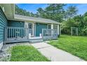 Inviting covered front porch with chairs and lion statues on a lovely home with a sidewalk approach at 2969 White Ne Rd, Conyers, GA 30012