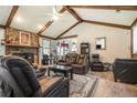 Open concept living room featuring wood floors, vaulted ceilings, exposed beams, and stone fireplace at 2969 White Ne Rd, Conyers, GA 30012
