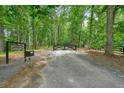 Long driveway leading through lush woods to the home at 326 Seldom Seen Trl, Canton, GA 30115