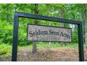 The Seldom Seen Acres sign welcomes you to the wooded property at 326 Seldom Seen Trl, Canton, GA 30115