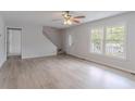 Bright living room with hardwood floors, large windows, and a welcoming front door at 19 Willowbrook Ct, Acworth, GA 30101