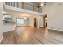 Spacious living area featuring hardwood flooring and a view of the stairs at 210 Riveredge Way, Mcdonough, GA 30252