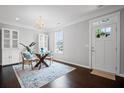 Bright dining area featuring a glass table, modern chairs, and elegant chandelier, perfect for entertaining at 149 Archie Way, Woodstock, GA 30188