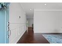 Welcoming entryway boasts beautiful dark wood floors and stylish molding, creating an inviting atmosphere at 149 Archie Way, Woodstock, GA 30188
