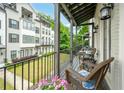 Relaxing balcony with wicker chairs overlooking a well-maintained lawn and neighborhood greenery at 2063 Wheaton Way, Sandy Springs, GA 30328