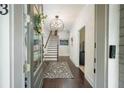 Inviting foyer with dark hardwood floors, a colorful rug, and an elegant chandelier at 2063 Wheaton Way, Sandy Springs, GA 30328