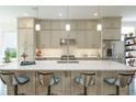 Spacious kitchen featuring a large island with seating, modern appliances, and ample cabinet space at 2063 Wheaton Way, Sandy Springs, GA 30328