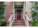 Brick steps lead to front entrance showcasing a bright red door with address numbers at 2114 Gorman Se Grv, Atlanta, GA 30316