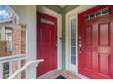 Two red front doors with sidelights offer a welcoming entrance to the townhome at 2114 Gorman Se Grv, Atlanta, GA 30316