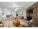 Inviting living room featuring a cozy stone fireplace, plush seating, and an open layout to the dining area at 765 Martin Rd, Stone Mountain, GA 30088
