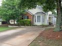 Exterior view of home showcasing the front yard landscaping and a long driveway at 2790 Barnwood Xing, Duluth, GA 30097