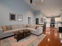 Cozy living room features a large sectional couch and seamless flow into the modern kitchen at 2790 Barnwood Xing, Duluth, GA 30097
