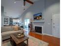Open concept living space featuring a fireplace and views into a modern kitchen at 2790 Barnwood Xing, Duluth, GA 30097