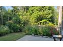 Tranquil backyard with flower garden and a patio area ideal for outdoor living at 3179 Woodward Down Trl, Buford, GA 30519