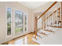 Inviting foyer with hardwood floors, a decorative glass door, and a staircase leading to the upper level at 5711 Brynwood Nw Cir, Acworth, GA 30101