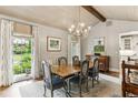 Bright dining room featuring a chandelier, large windows with backyard views, and elegant decor at 80 Maryeanna Dr, Sandy Springs, GA 30342