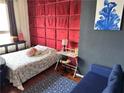 Bedroom features a padded headboard, writing desk and chair, and a blue sofa at 20 Marietta Nw St # 13C, Atlanta, GA 30303