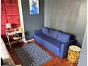 Cozy bedroom features a blue sofa and a striking piece of modern art above it at 20 Marietta Nw St # 13C, Atlanta, GA 30303