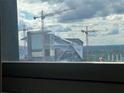 View of Atlanta Falcons Stadium framed by window looking out to sky at 20 Marietta Nw St # 13C, Atlanta, GA 30303