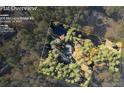 Aerial view of a sprawling property with a home, tennis court, and surrounded by trees at 200 Mcguirts Bridge Rd, Covington, GA 30014