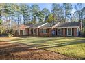 Expansive brick home with a well-maintained lawn and classic architectural details at 200 Mcguirts Bridge Rd, Covington, GA 30014