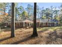 Classic brick home on a spacious lot, framed by mature trees and a lush lawn at 200 Mcguirts Bridge Rd, Covington, GA 30014
