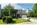 Charming one story brick home with a well manicured lawn, two-car garage, and inviting blue front door at 2163 Berryhill Se Cir, Smyrna, GA 30082