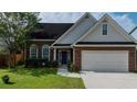 Charming one story brick home with a well manicured lawn, two-car garage, and inviting blue front door at 2163 Berryhill Se Cir, Smyrna, GA 30082