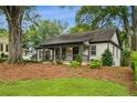 Attractive home featuring a covered front porch and a green, manicured lawn at 2201 Plantation Ln, Atlanta, GA 30341