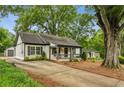 Beautiful home with a long driveway, lush trees, and mature landscaping at 2201 Plantation Ln, Atlanta, GA 30341