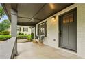 Inviting covered porch with seating, offering a cozy outdoor space to relax at 2201 Plantation Ln, Atlanta, GA 30341
