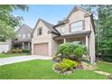 Attractive two-story brick home with a lush green lawn and a well-kept garden at 2720 Tuscany Park Dr, Lawrenceville, GA 30043