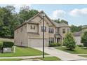 Beautiful two-story home with brick and siding, featuring a well-kept lawn and two car garage at 3748 Spring Place Ct, Loganville, GA 30052