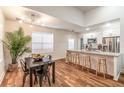Dining room with table, chairs, hardwood floors and a view of the open kitchen concept at 20 S Eugenia Nw Pl, Atlanta, GA 30318