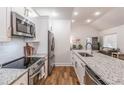 Modern kitchen with stainless steel appliances, granite countertops and an open design at 20 S Eugenia Nw Pl, Atlanta, GA 30318