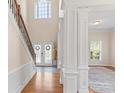 Beautiful foyer entrance featuring a staircase, columns, a large window, and hardwood floors at 3113 Brians Creek Se Dr, Conyers, GA 30013