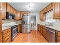 Efficient kitchen featuring stainless steel appliances, wood cabinets, and ample counter space for meal preparation at 564 Allana Ct, Stone Mountain, GA 30087