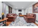 Comfortable living area with fireplace, neutral furniture, and bright lighting creating a cozy atmosphere at 564 Allana Ct, Stone Mountain, GA 30087