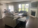 Open living room with fireplace, large windows, and comfortable seating at 209 Ellis Ln, Woodstock, GA 30189