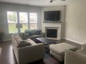 Bright living room featuring a fireplace and comfortable seating arrangements at 209 Ellis Ln, Woodstock, GA 30189