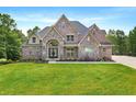 Beautiful two-story brick home with manicured lawn and arched entryway at 7519 Waterview Cv, Douglasville, GA 30135