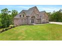 Charming two-story brick home on a spacious lot with lush green lawn at 7519 Waterview Cv, Douglasville, GA 30135