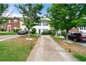 Charming townhome featuring a well-maintained lawn and long driveway at 1320 Revelstoke Cv, Riverdale, GA 30296