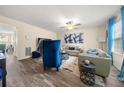 Bright living room features hardwood floors, a ceiling fan and updated furniture at 1320 Revelstoke Cv, Riverdale, GA 30296