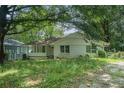 Charming one-story home with a covered front porch and a mature, tree-filled front yard at 1212 Eastridge Sw Rd, Atlanta, GA 30311