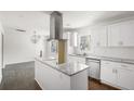 Bright kitchen features white cabinetry, granite countertops, stainless steel appliances and center island at 1212 Eastridge Sw Rd, Atlanta, GA 30311