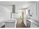 Bright kitchen features white cabinetry, granite countertops, stainless steel appliances and center island at 1212 Eastridge Sw Rd, Atlanta, GA 30311